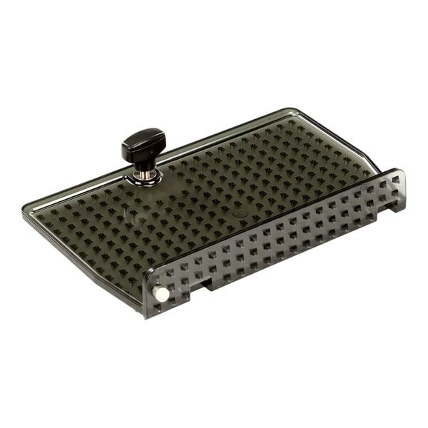 A rectangular metal remnant holder with a textured surface and a short bolt handle on top.