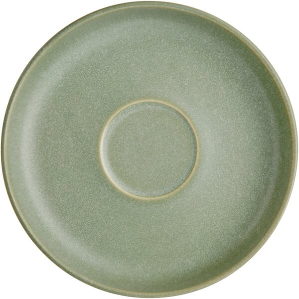 A round, sage green saucer with a matte finish and a circular indentation in the center.