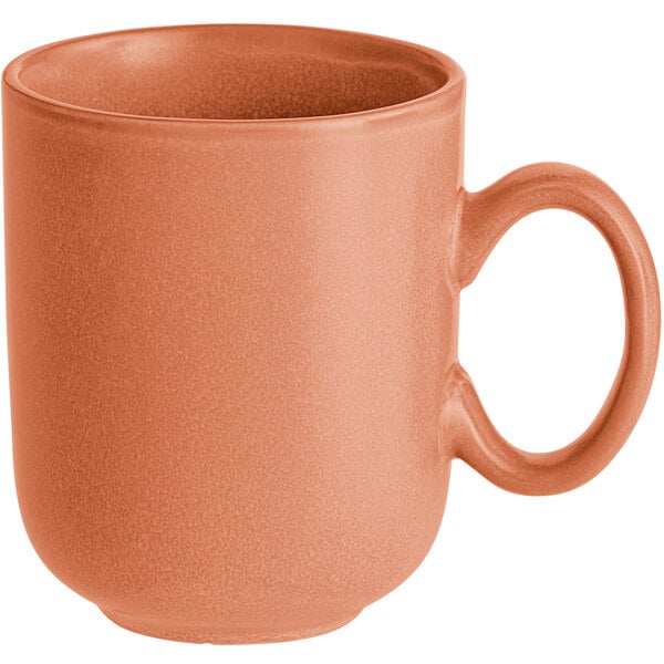 A matte-finish, terra cotta-colored porcelain mug with a large handle.