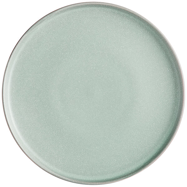 A round, matte, light blue plate with a smooth surface and slightly raised rim.
