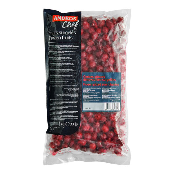 A clear plastic bag filled with frozen red cherries, labeled as "Frozen pitted sour cherries" and weighing 2.2 lbs.