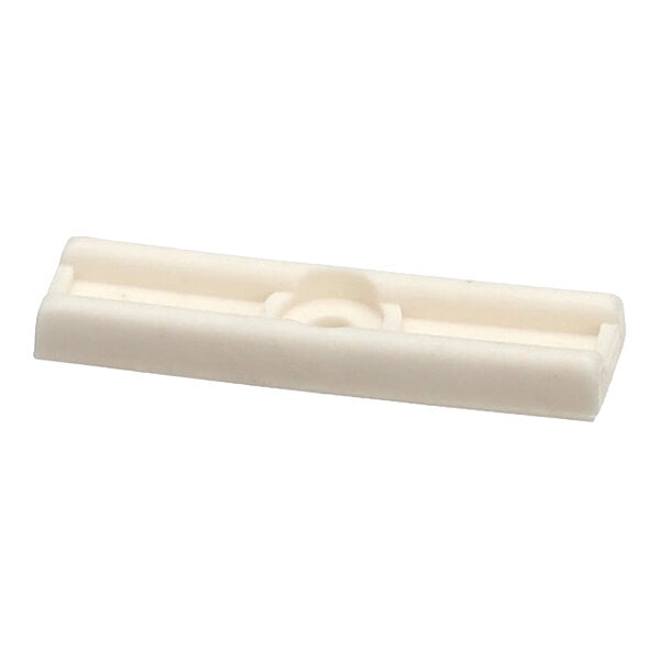 A white rectangular plastic door glide component.