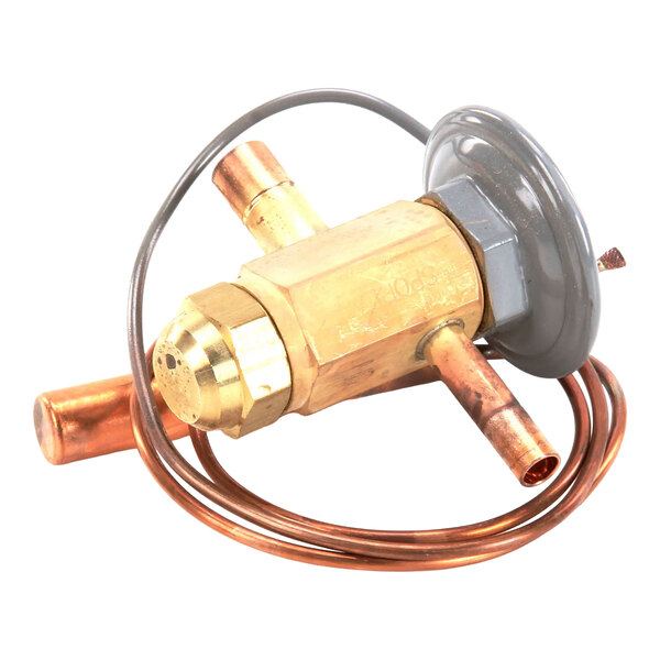 A white 2-ply dinner napkin placed on a wooden table with a fork resting on top.