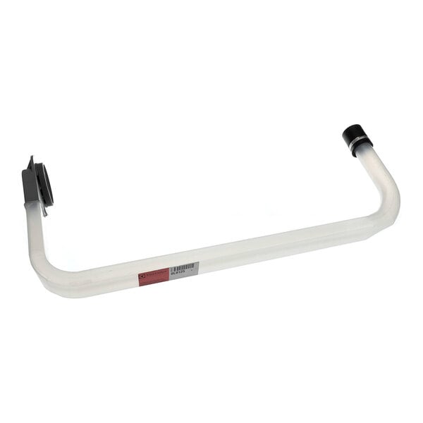 A white 2-ply dinner napkin placed on a wooden table with a fork resting on top.