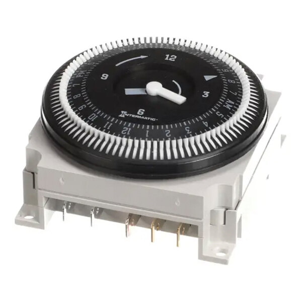 A mechanical timer module with a circular dial and multiple electrical terminals, used for controlling electrical circuits.
