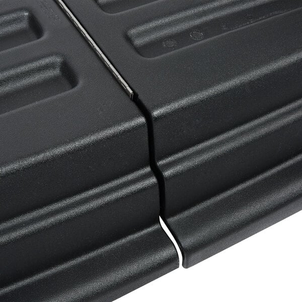 A close up of a black plastic Rubbermaid hinged dome lid.