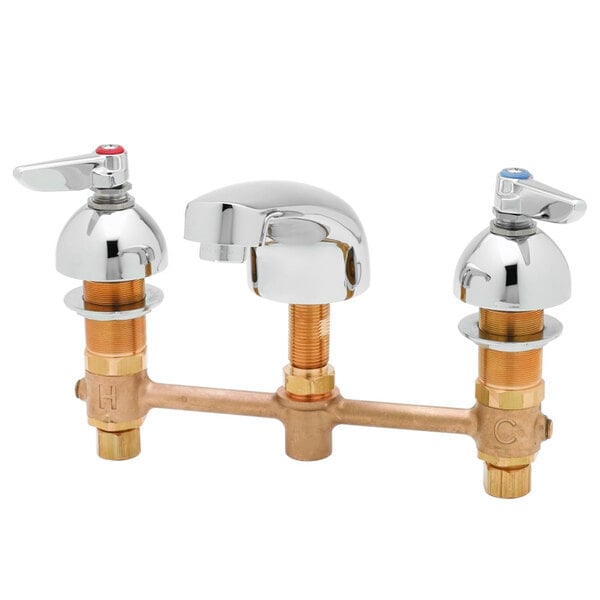 A close-up of a T&S brass deck mount faucet with chrome and brass lever handles.