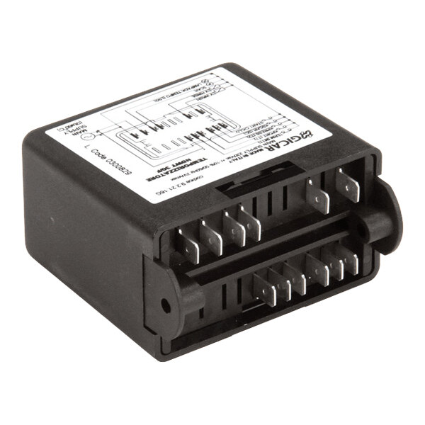 A rectangular electronic main board module with multiple metal prongs and a labeled diagram on top.