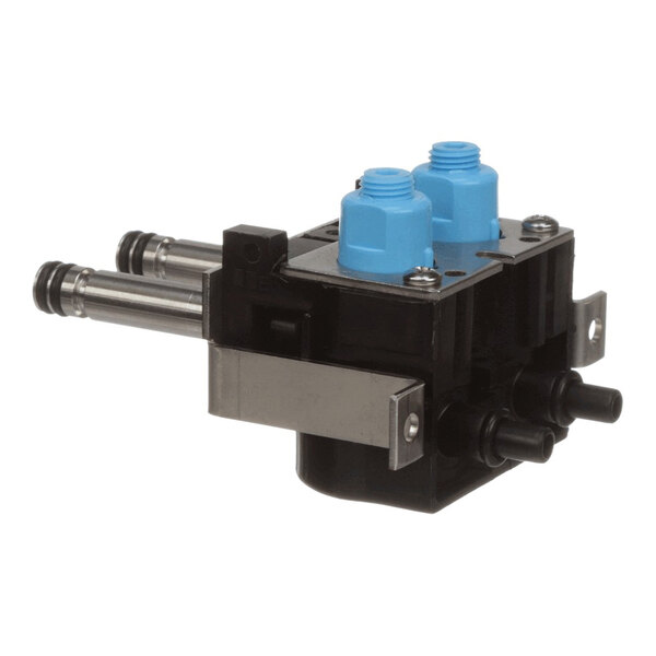 A black Flowmatic valve kit with two blue caps and multiple connection ports.
