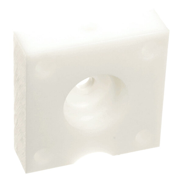 A small, white, rectangular spacer block with a central hole and rounded edges.