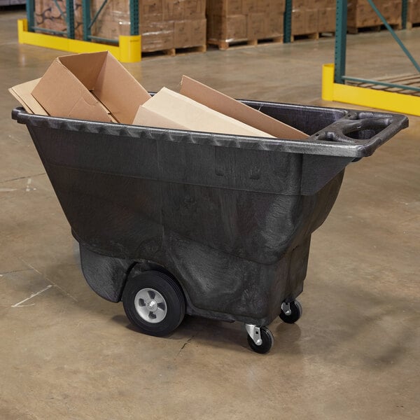 A large black Rubbermaid tilt truck filled with cardboard boxes.