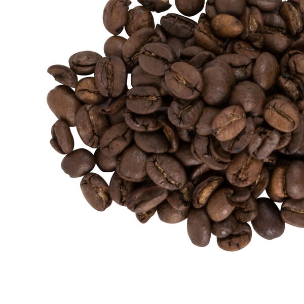 A pile of Crown Beverages Emperor's Finest whole coffee beans on a white background.