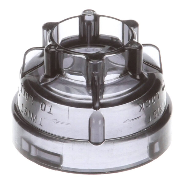 A black plastic nozzle valve component for a beverage dispensing machine.