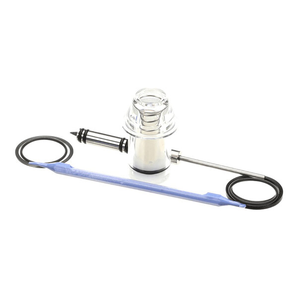 A rebuild kit for an FCB domed faceplate, including a clear plastic component, a metal rod, a blue tool, and rubber O-rings.