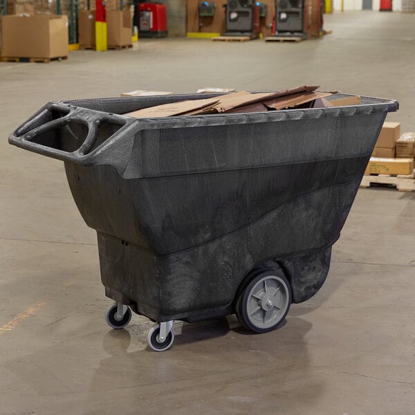 A black Rubbermaid tilt truck for industrial trash.
