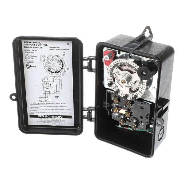 A refrigeration defrost control timer with an open black enclosure showing internal components and wiring diagram.