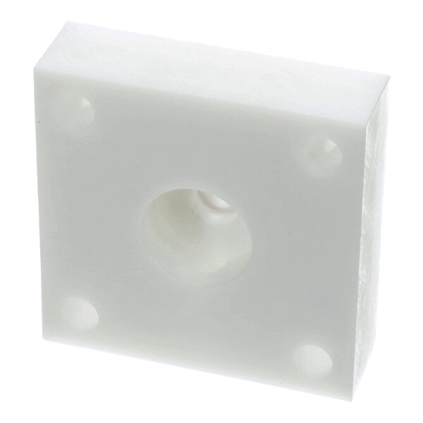 A white, square plastic spacer block with a central hole and four corner holes.