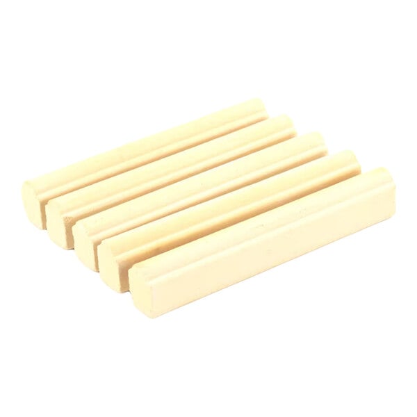 A set of five beige, cylindrical ceramic briquettes for use in grills or broilers.