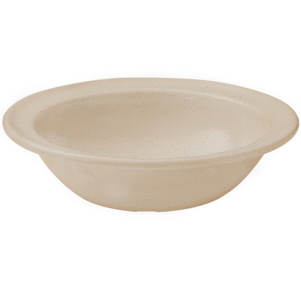 A white bowl with a beige rim on a speckled surface.