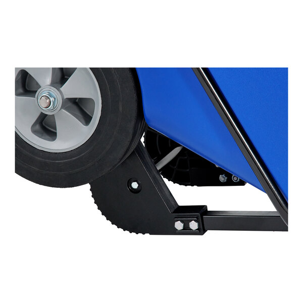 The wheel and tire of a blue Rubbermaid Brute tilt cart.