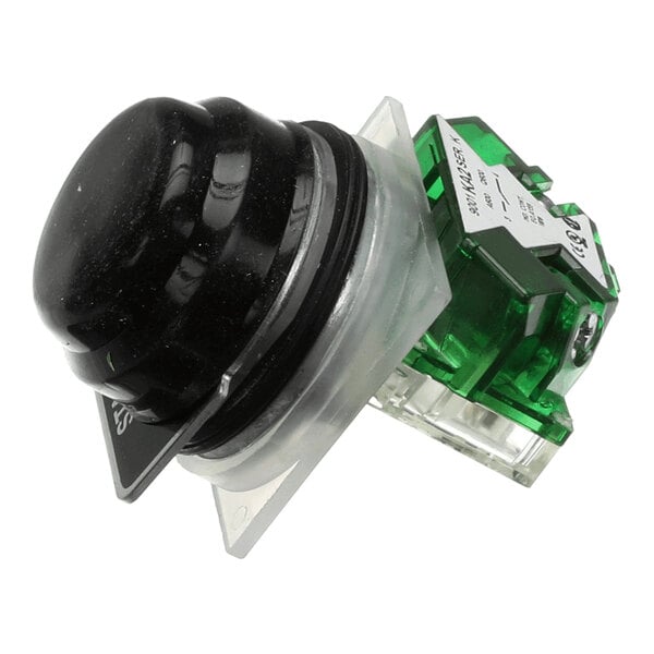 A black start switch assembly with a protective boot and green housing.