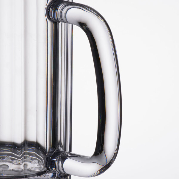 A close up of a Carlisle clear plastic beer mug with a handle.