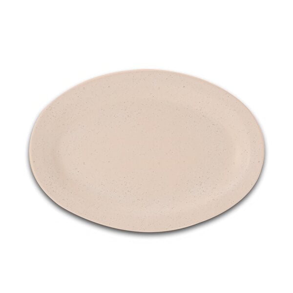 A sandstone oval platter with a white surface and black specks.