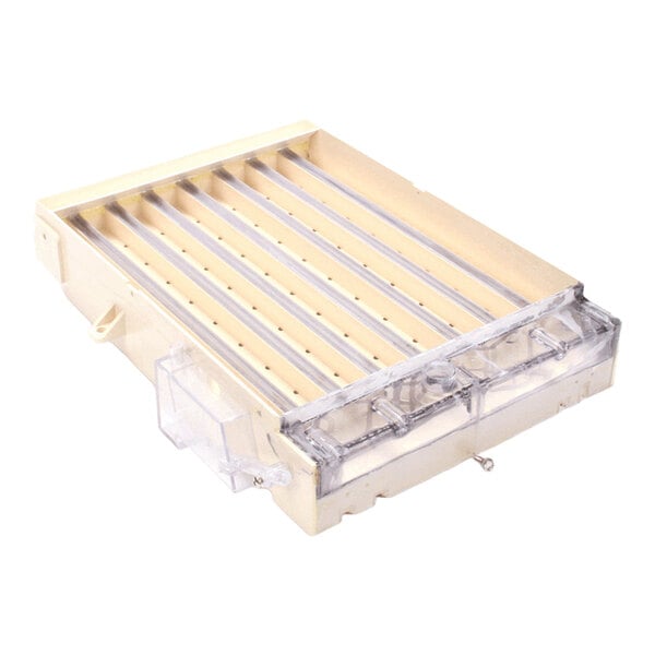 A beige and clear plastic water plate component for a Kold-Draft ice machine.