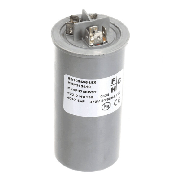 A cylindrical electrical capacitor with labeled specifications and metal terminals on top.