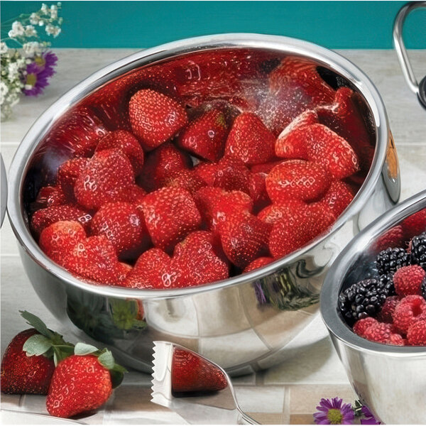 A white Bon Chef double wall bowl filled with strawberries.