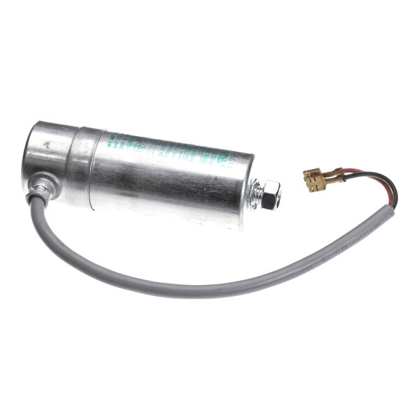 A cylindrical metal run capacitor with an attached wire and connector, used in refrigeration equipment.