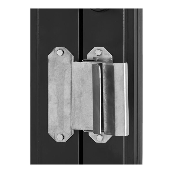 A metal latch mechanism attached to a black frame, likely part of a door or window security system.