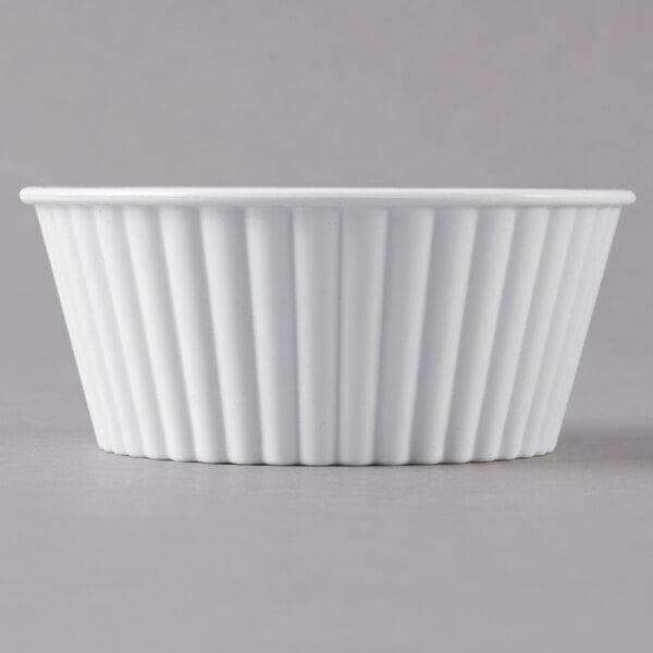 A white Carlisle fluted plastic ramekin.