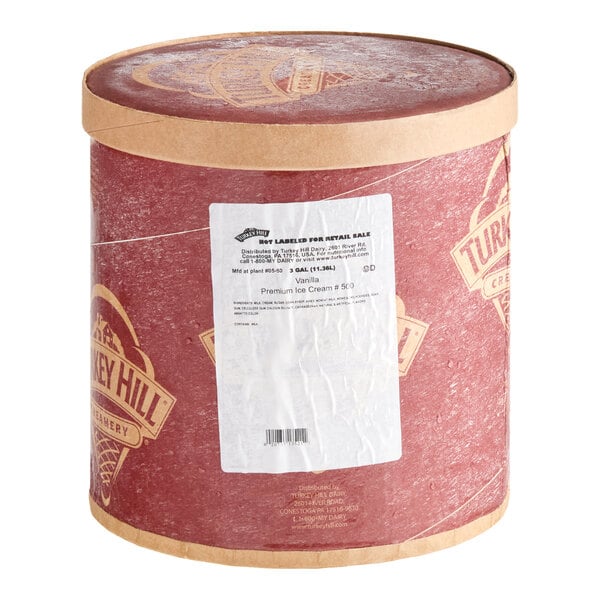 A large round container with a red and tan design, labeled as Turkey Hill vanilla ice cream, holding 3 gallons.