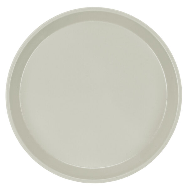 A close-up of a round white Cambro fiberglass tray with a round rim.