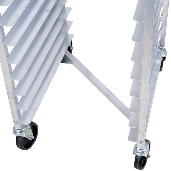 A metal sheet pan oven rack with multiple slots and caster wheels.