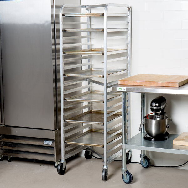 A tall metal sheet pan rack with multiple shelves on wheels, designed for holding baking trays in a commercial kitchen.