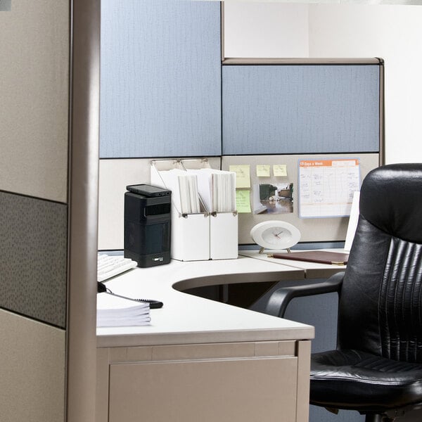 An OdorStop OSAP2B black 3-speed HEPA air purifier placed on a desk in an office cubicle.