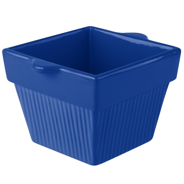 A cobalt blue square bowl with handles.