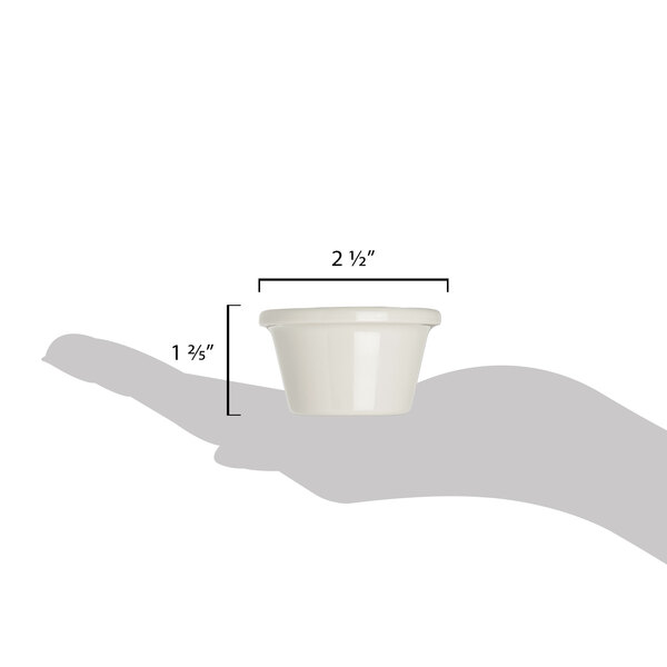 A hand holding a white Carlisle plastic ramekin with measurements.