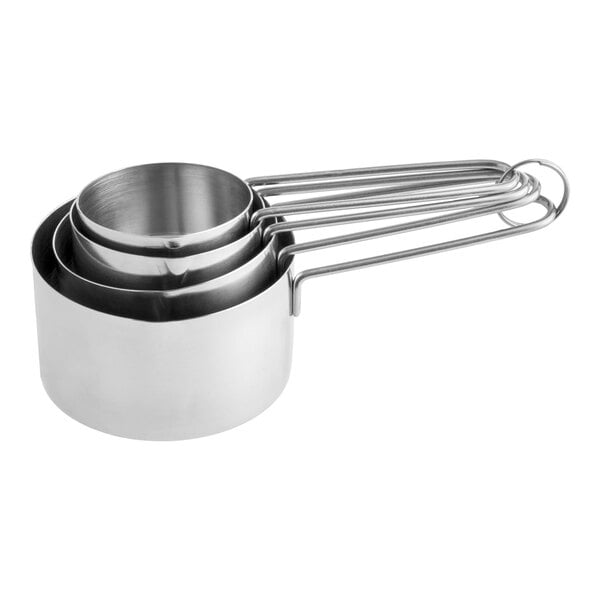 A set of four stainless steel measuring cups with wire handles nested together.