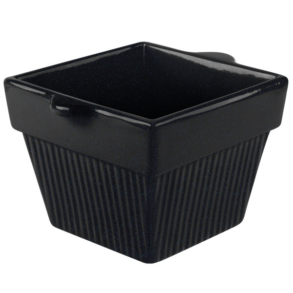 A black square cast aluminum bowl with a handle.
