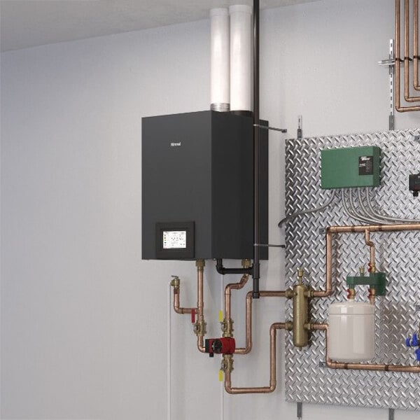 A wall-mounted Rinnai RCB Series natural gas indoor heat-only boiler with visible piping and control panel.