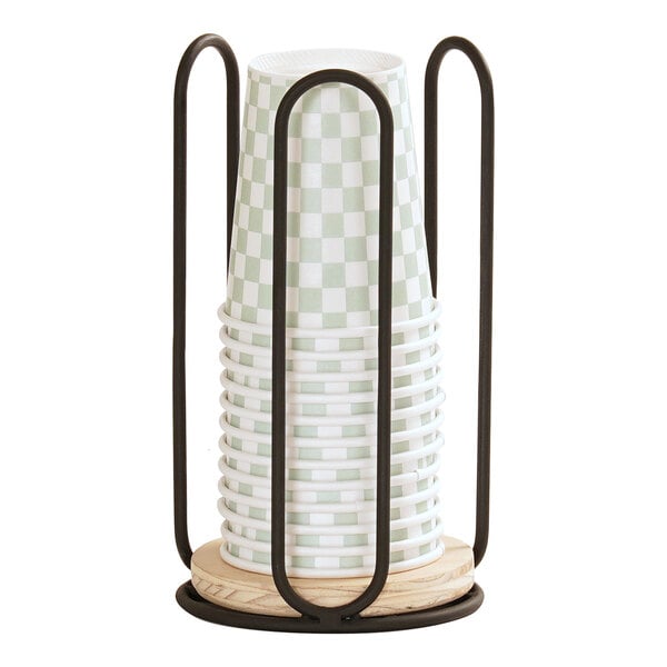 A black wire and birch wood organizer holding a stack of checkered paper cups.