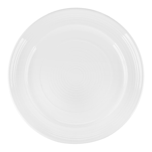 A close-up of a Tuxton Concentrix white china plate with a circular rim.
