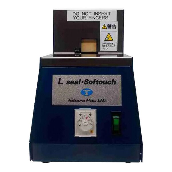 A semi-automatic L-clip tape applicator machine labeled 'L seal-Softouch' by Takara Pac LTD.