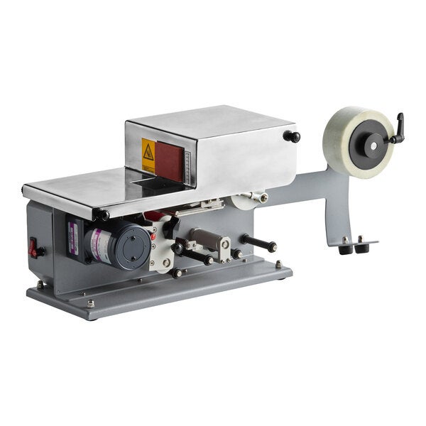 A semi-automatic L-clip tape applicator machine with a roll of tape mounted on the side.