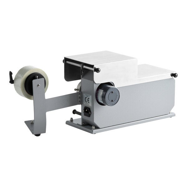 A semi-automatic L-clip tape applicator machine with a mounted roll of tape.