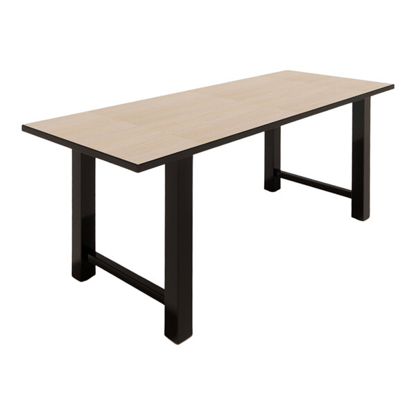 A rectangular standard height table with a beigewood laminate top and black legs.