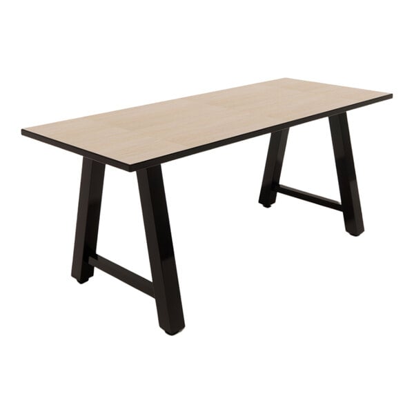 A rectangular standard height table with a beigewood laminate top and black angled legs.